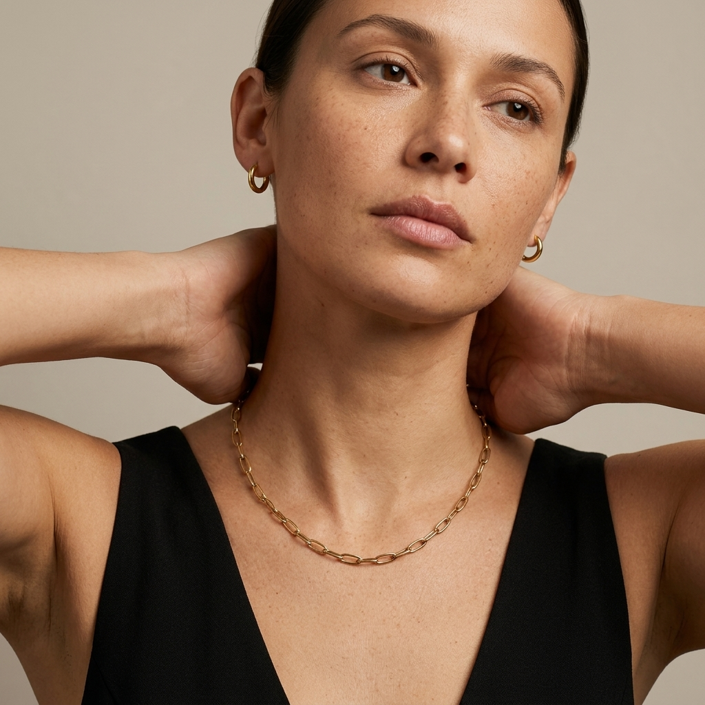 woman in black dress wearing 18ct gold plated Sunday Paperclip Necklace at the re.edit