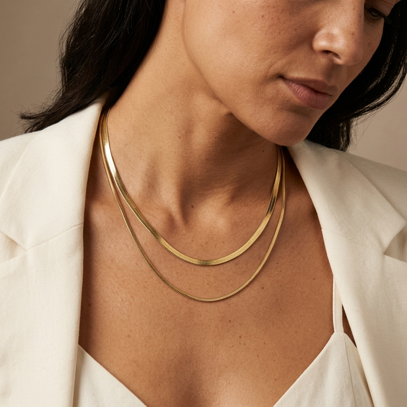 Model wearing the Shoreline Layered Necklace, a gold layered herringbone necklace designed as an elegant everyday jewellery foundation.