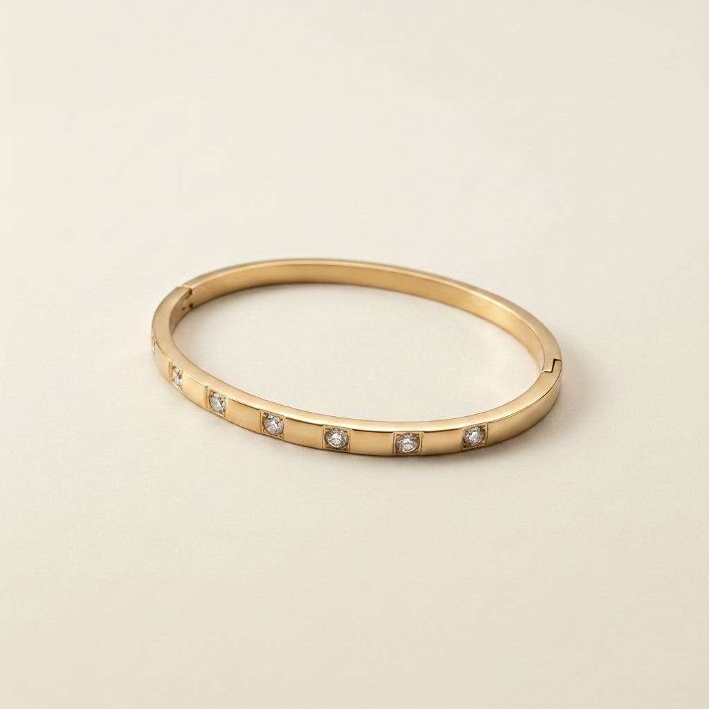 Whitecliff Crystal Bangle laid flat to show the polished gold and cubic zirconia details