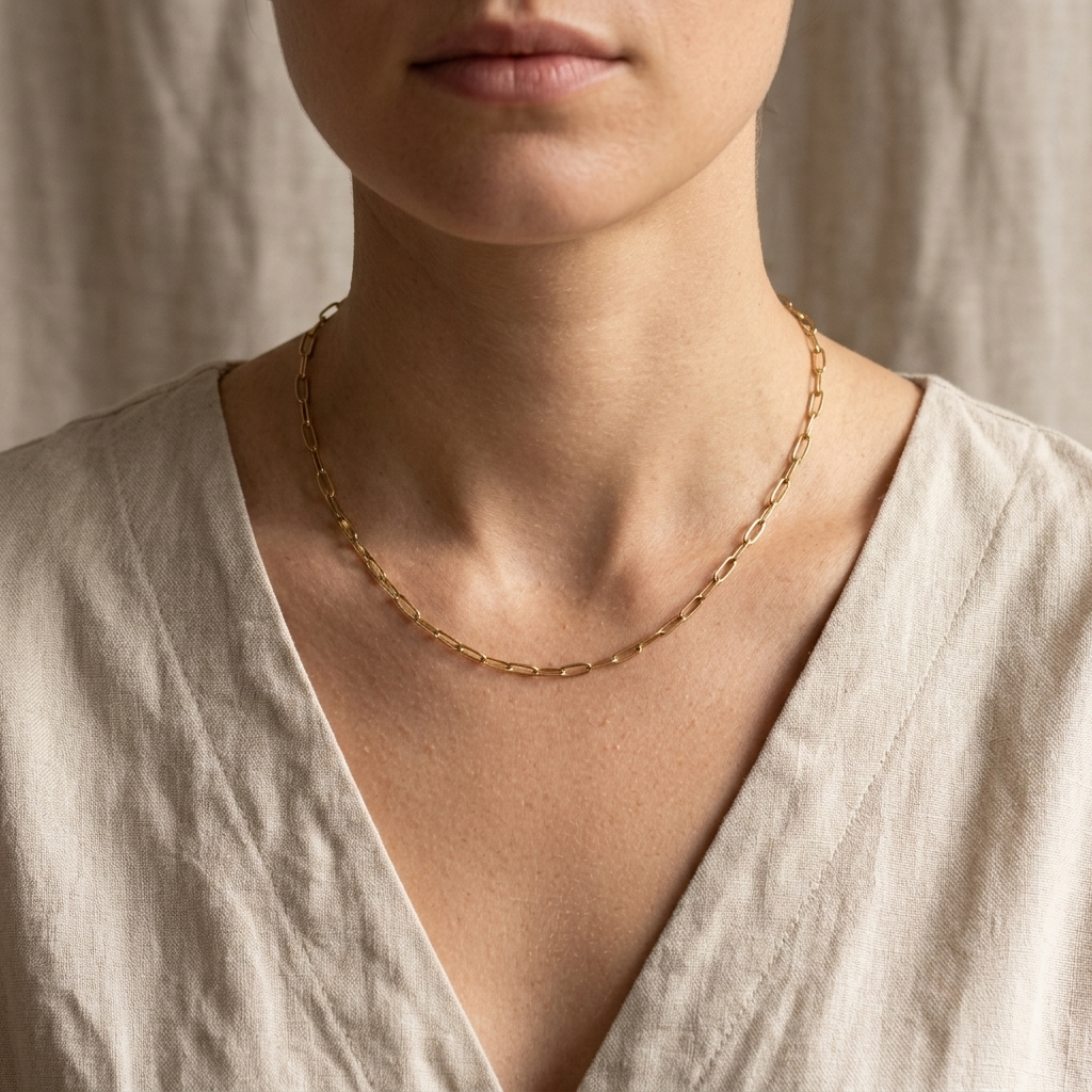 Model wearing the Sunday Paperclip Chain Necklace with a soft linen top