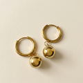Pair of Luna Drop Earrings with polished gold hoops and rounded ball drops