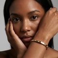 Model wearing the Whitecliff Crystal Bangle with hands raised near her face