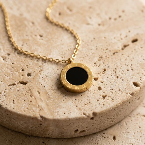 Cove Reversible Pendant Necklace showing the black glass side on pale travertine