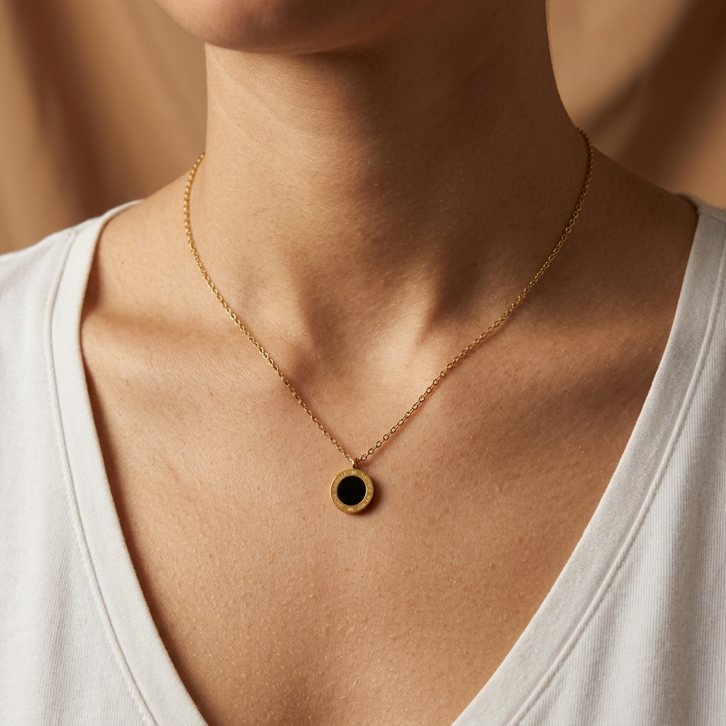 Model wearing the black glass side of the Cove Reversible Pendant Necklace