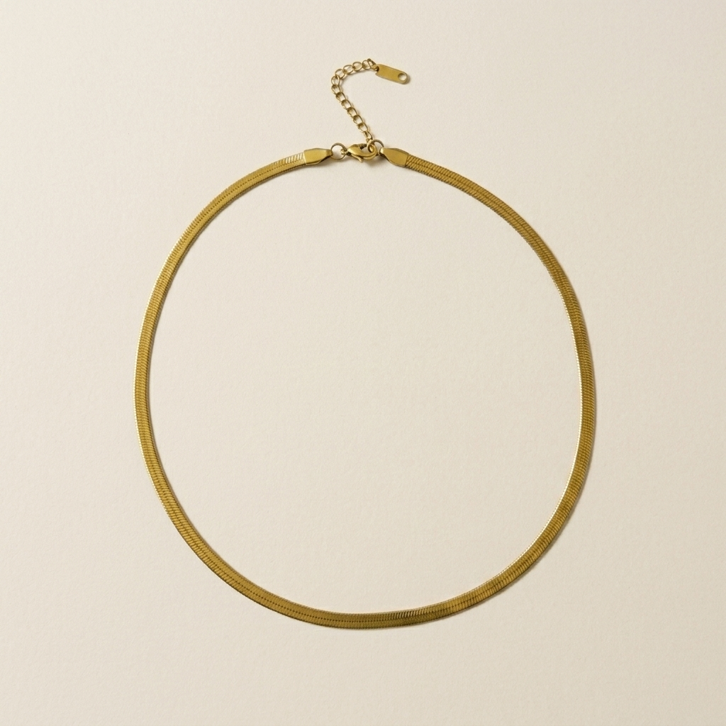 18ct gold plated Shoreline Herringbone Necklace laid flat on a neutral background