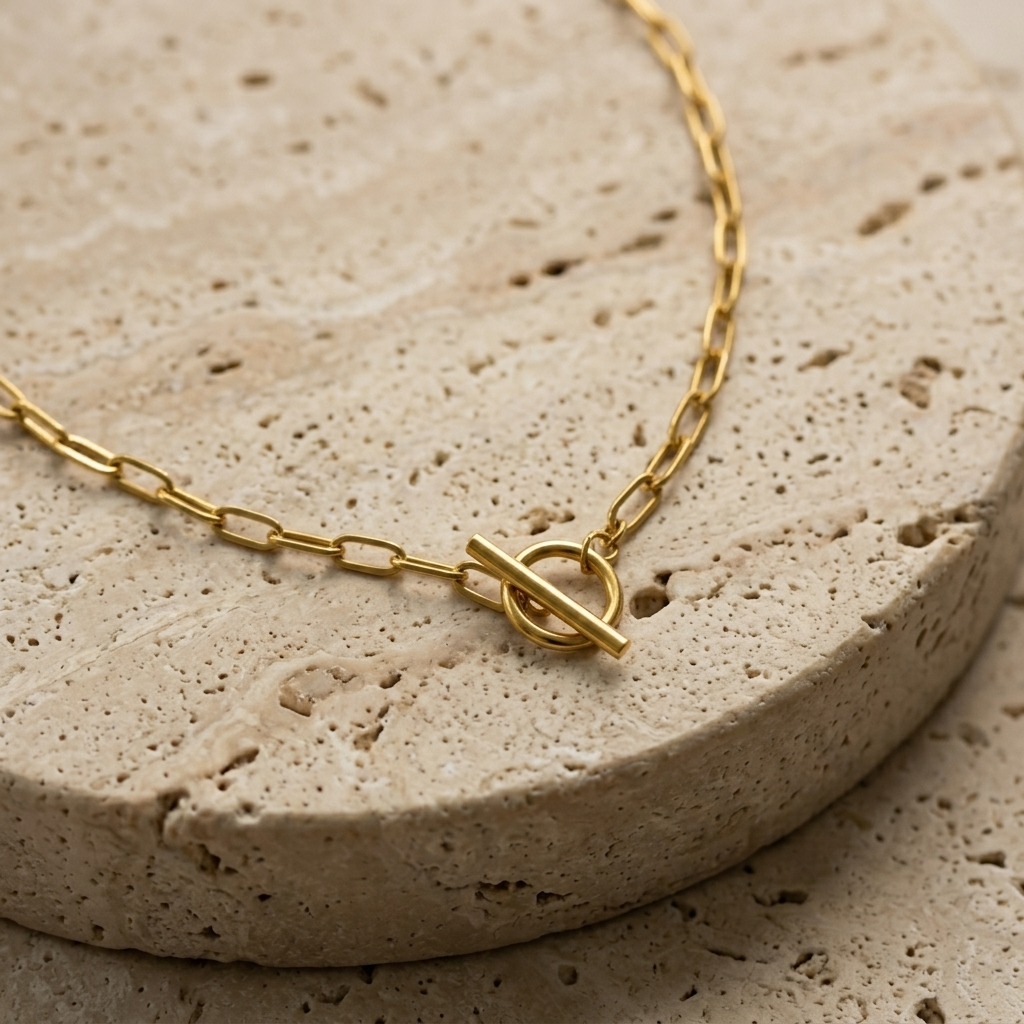 Close-up of the Travertine T-Bar Necklace toggle clasp on pale travertine