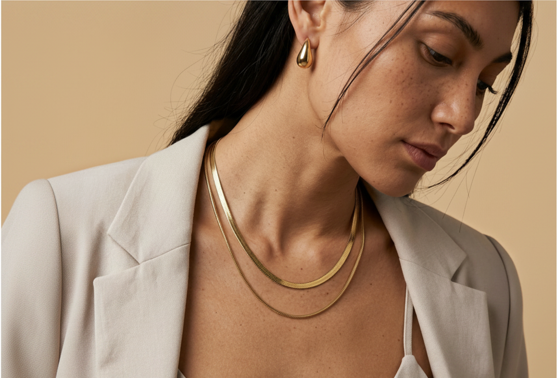 Model wearing the Shoreline Layered Necklace and Morning Light Teardrop Earrings